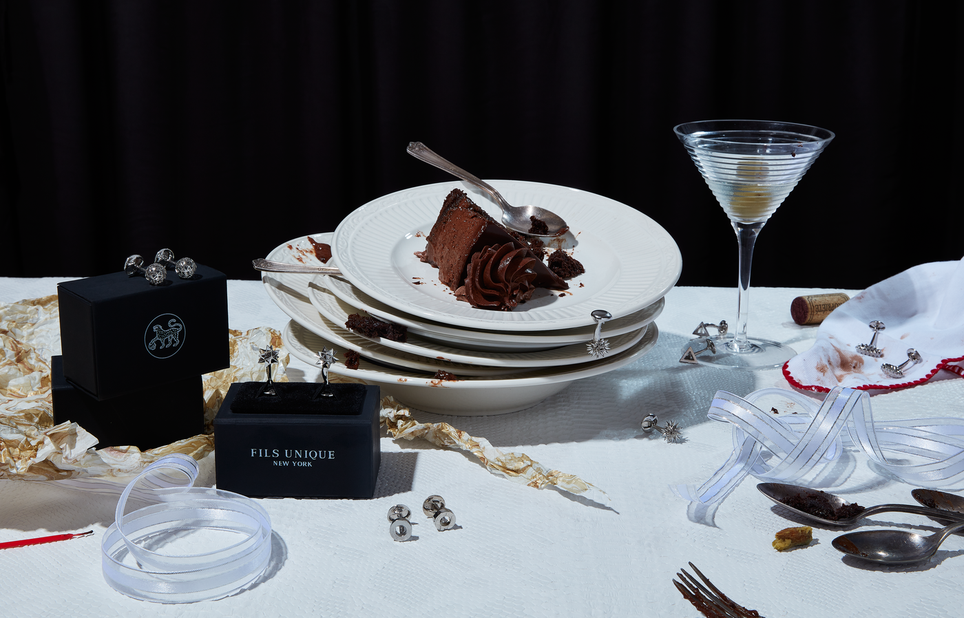 a photo depicting the leftovers of a dinner with silver cufflinks 